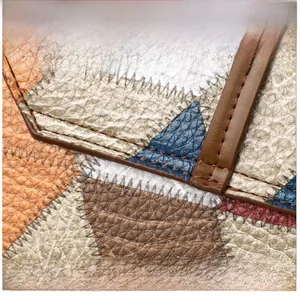 Detailed close-up of premium lychee grain texture and geometric patchwork stitching