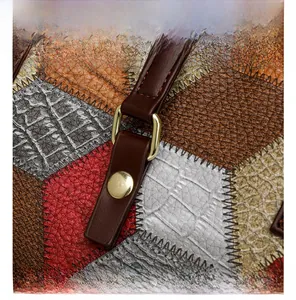 Macro view of multi-textured leather patchwork detail with golden metal buckle and rivets