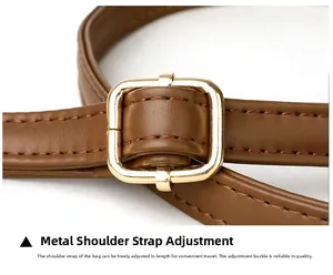 Close-up of adjustable brown leather shoulder strap with premium gold metal buckle detail