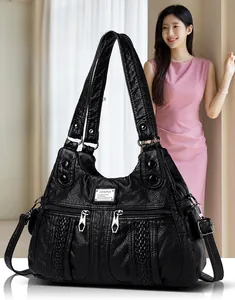 Detail of black pebbled leather texture with silver zipper and woven stripe pattern