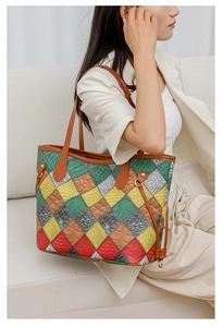 Detail of color-block tote bag featuring animal texture leather patterns with spacious interior