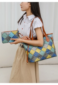 Close-up of colorful crocodile embossed patchwork tote bag set with metal charm details