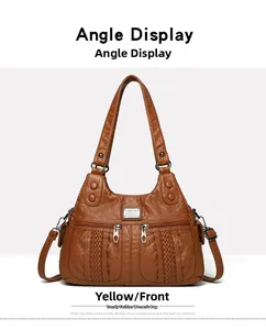 Front view of yellow soft leather shoulder bag featuring dual zipper pockets and texture