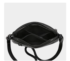 Detailed interior view of black lychee leather crossbody bag with multiple compartments