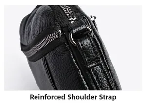 Close-up of reinforced shoulder strap stitching and metal D-ring on black litchi leather bag