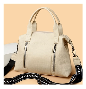 Detail of cream tote bag featuring lychee texture and geometric pattern strap