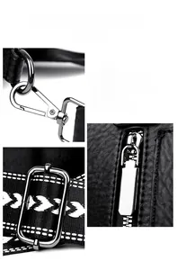 Close-up of polished silver hardware and woven strap on black pebble leather bag