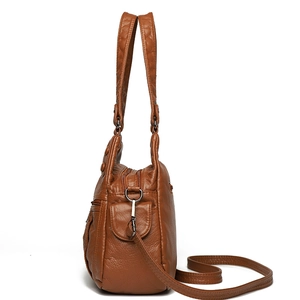 Brown soft leather multi-pocket shoulder bag with crossbody strap and gunmetal hardware