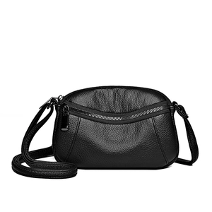 Minimalist black lychee leather crossbody bag with dual silver zippers and slim strap