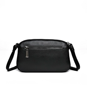 Elegant black lychee grain leather crossbody bag with silver zipper and slim shoulder strap