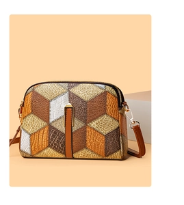 Detailed view of color-block crossbody bag featuring crocodile and ostrich textures