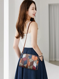 Detail view of colorful patchwork crossbody bag with textured faux leather and zippers