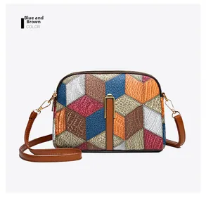 Detail of color-block crossbody bag featuring 3D geometric patterns and crocodile texture