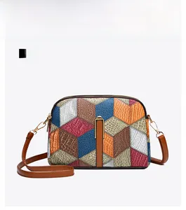 Front view of geometric patchwork crossbody bag with textured leather and gold hardware