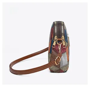 Side view of multi-color patchwork shoulder bag with dual zippers and golden hardware