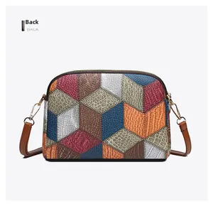 Detailed back view of patchwork leather crossbody bag with geometric multi-texture patterns