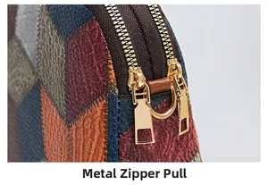 Detail of premium golden hardware zipper puller on color-block lychee textured leather bag