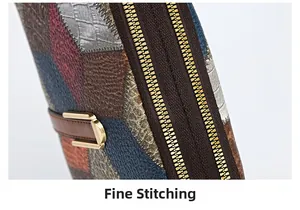 Detail of multi-color patchwork leather bag with double gold zippers and fine stitching