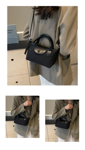 Macro detail of the nylon fabric with leather flap and embossed snap button closure