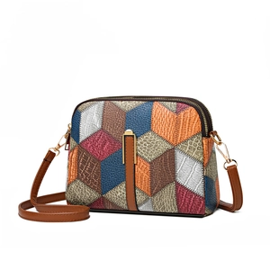 Ethnic patchwork crossbody bag with 3D geometric design and double zipper hardware