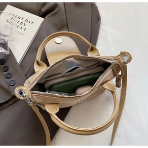 Interior view of nylon crossbody bag with zipper pocket and card slots for organization
