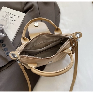 Interior detail of nylon handbag with zipper pocket and herringbone fabric lining