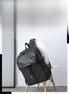 Detail of black business backpack with waterproof fabric on a white chair
