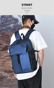 Detail of dark blue waterproof nylon business backpack with side mesh pocket and flap pocket