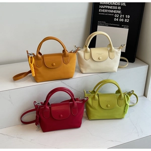 Detailed display of small nylon crossbody bags in yellow, beige, burgundy and green