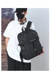 Detailed side view of black waterproof backpack featuring buckle flap and mesh side pocket