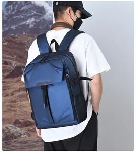 Detail of dark blue business backpack with flap buckle and multiple functional zip pockets