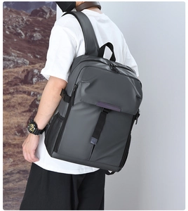 Detail of dark gray business backpack featuring water-resistant fabric and side mesh pocket