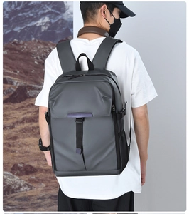 Waterproof grey business backpack for men shown from side view on male model