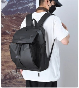Waterproof black business backpack with multi-pocket design on model against mountain background