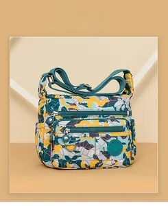 Detail view of water-resistant oxford shoulder bag with colorful camouflage print