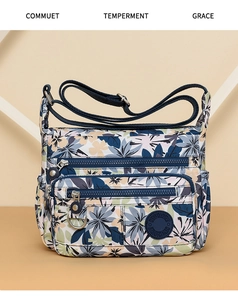 Close-up of floral print crossbody bag featuring multiple zipper pockets and adjustable strap