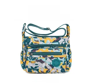 Close-up of waterproof printed oxford fabric cross-body bag with multi-pocket details