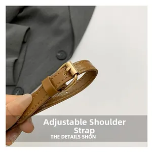 Close-up of adjustable brown leather strap with polished golden metal pin buckle