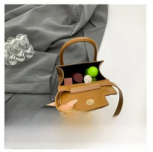Detailed interior view of a brown leather mini bag showing lipstick storage capacity