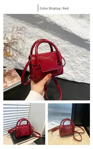 Detail of a bright red mini top-handle bag with a glossy patent leather texture and strap