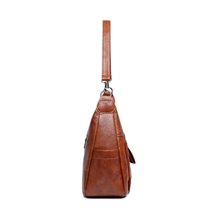 Brown vintage faux leather crossbody bag with spacious side pocket and wide strap