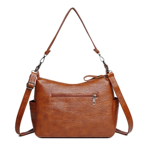 Classic dark brown pebble leather shoulder bag with adjustable strap and side pockets