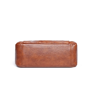 Bottom view of large brown faux leather crossbody bag with high-quality pebble texture