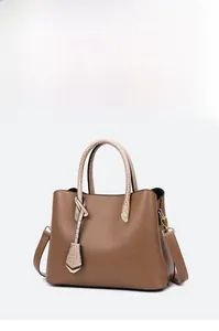 Detail of brown litchi pattern tote bag featuring light crocodile texture handles