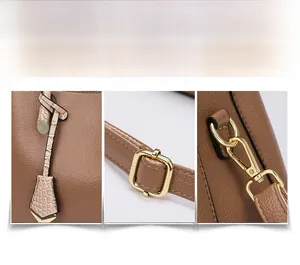 Detail of brown litchi pattern leather tote bag with gold metal buckles and charms