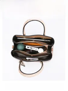 Detail view of large tote bag interior with iPad and daily essentials in compartments