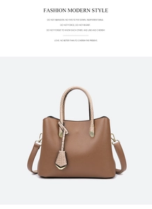 Detail of brown litchi leather tote bag with beige croc-pattern handles and gold buckle