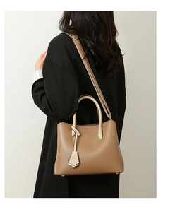 Brown lychee leather tote bag with snakeskin pattern handles and adjustable strap detail