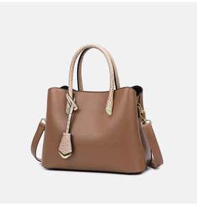 Detailed macro of brown lychee grain texture and light beige snakeskin pattern handles