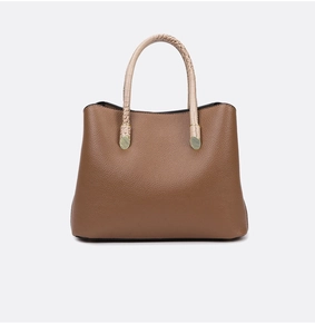 Detail of tan lychee grain leather tote bag with cream crocodile embossed handles